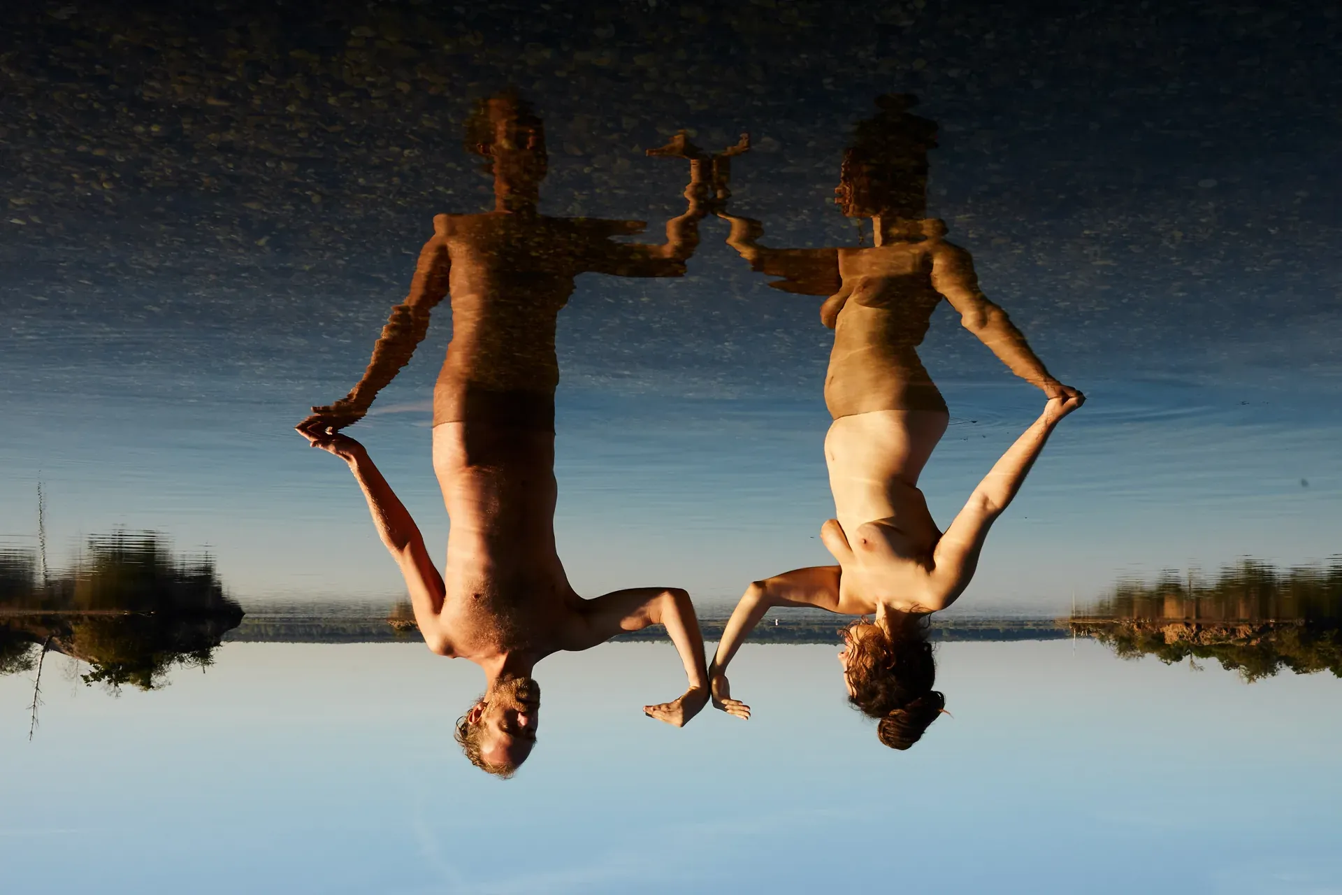 Wildbaden — zwei Figuren im stillen See in der Dämmerung